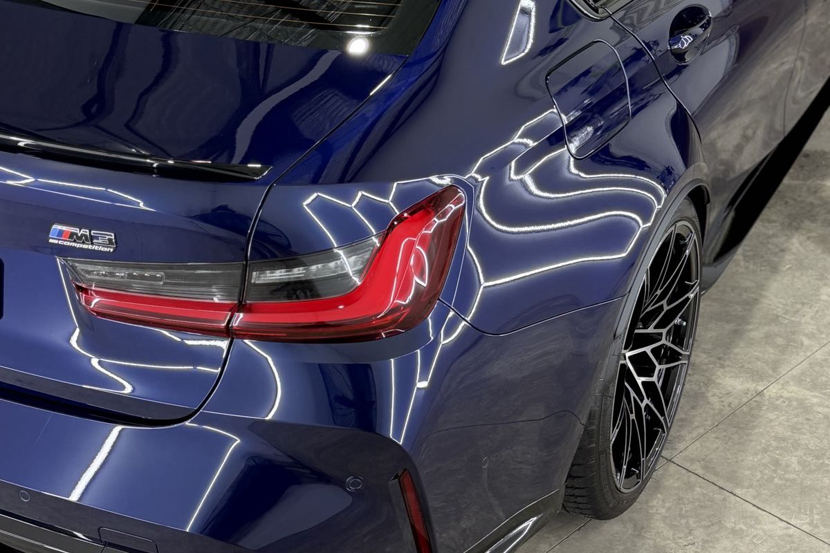 A ceramic-coated BMW M3 Competition with deep, glossy reflections at the J-Bros Detailing workshop in Burleigh Waters