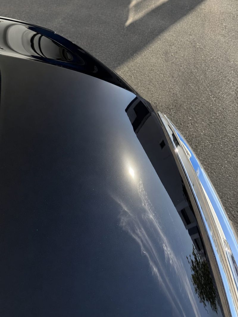 The same black Mitsubishi Triton with a deep, swirl-free mirror gloss after a J-Bros paint correction on the Gold Coast